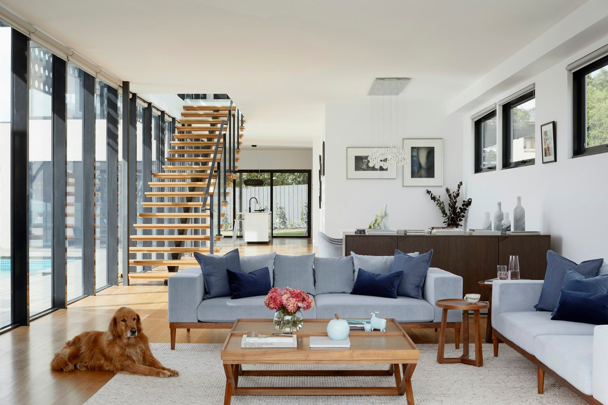Light-filled great room with floor-to-ceiling glass — the spirit of The Granite model
